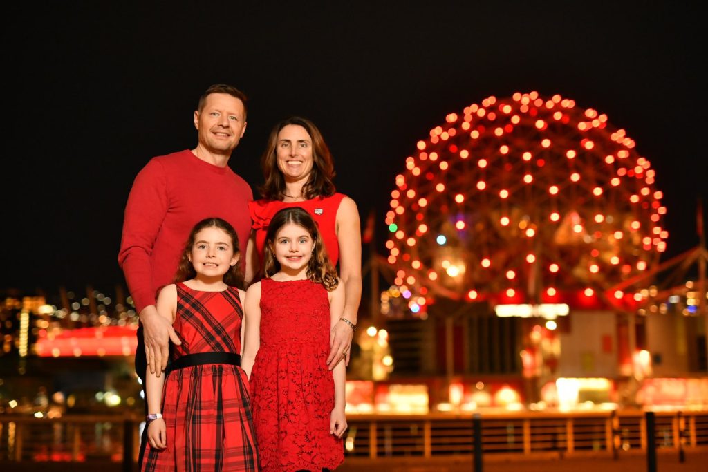 Dr. Sedlak and her family in front Science World, one of several Canadian landmarks illuminated red for #WearRedCanada on February 13.